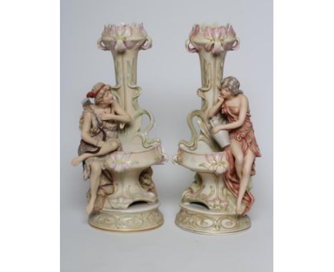 A PAIR OF ROYAL DUX FIGURAL VASES, early 20th century, the young male wearing a goatskin and carrying a bow and quiver and hi