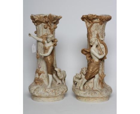 A PAIR OF ROYAL DUX FIGURAL VASES, early 20th century, the young man playing a lyre, with two lions at his feet and his femal