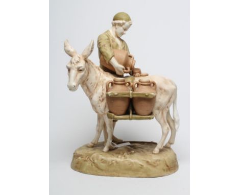 A ROYAL DUX FIGURE, early 20th century, the young man standing beside his donkey carrying panniers of amphora, on an oval bas