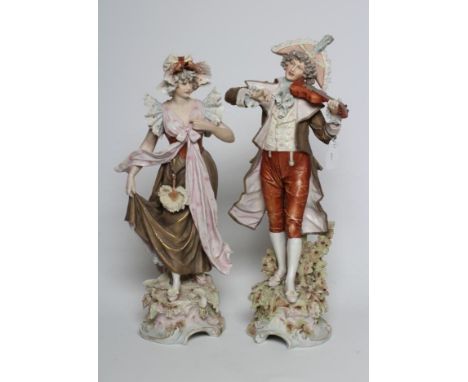 A PAIR OF ROYAL DUX FIGURES, early 20th century, the male playing a violin with his female dancing companion, both wearing 18