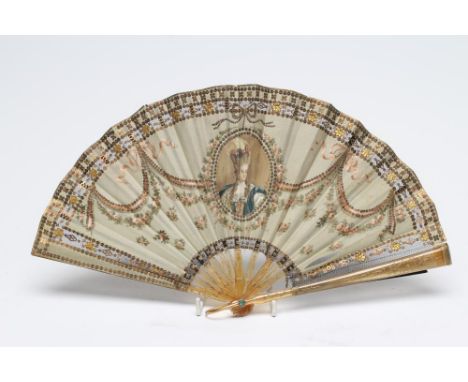 A FRENCH FAN, circa 1900, the pale green silk leaf centred by a portrait of Marie-Antoinette within ribbon tied swags and gil