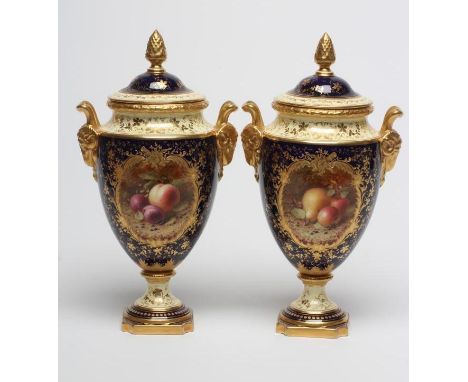 A PAIR OF COALPORT CHINA VASES AND COVERS of ovoid pedestal form, painted by H. Chivers with cartouche of fruits on a mossy b
