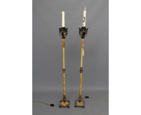 A PAIR OF ITALIAN WROUGHT IRON AND PARCEL GILT STANDARD LAMPS, 20th century, the turned velvet covered column with tasselled 
