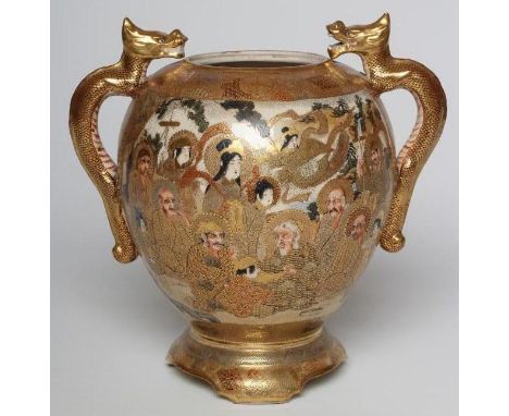 A SATSUMA EARTHENWARE VASE of rounded flared form with two dragon handles on a fixed "stand" and bracket feet, painted in typ