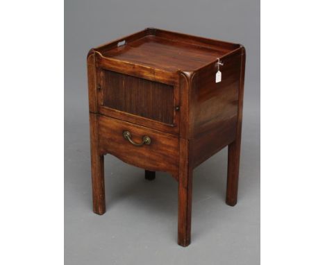 A GEORGIAN MAHOGANY NIGHT COMMODE, late 18th century, the tray top with pierced handles, the fascia with tambour door over a 