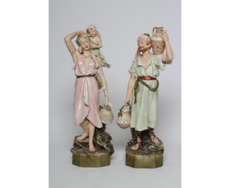 A PAIR OF ROYAL DUX MIDDLE EASTERN WATER CARRIER FIGURES, early 20th century, the male holding an amphora on his left shoulde