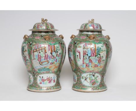 A PAIR OF CHINESE PORCELAIN JARS AND COVERS of inverted baluster form each with four pierced mask lugs to the shoulders, pain