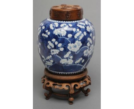 A CHINESE PORCELAIN JAR painted in underglaze blue with cracked ice and prunus, bears four character mark, 7 1/2" high, toget