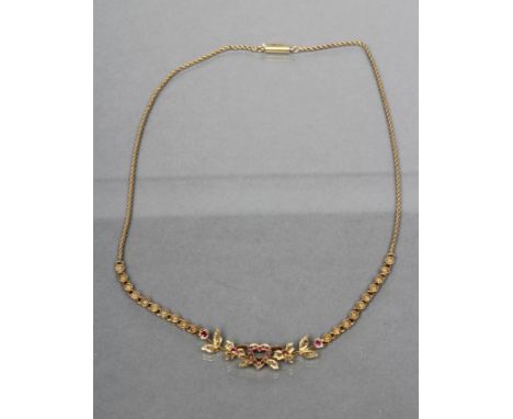 AN EDWARDIAN NECKLET, the central open heart set with small rubies and diamonds to a rose cut diamond and ruby set foliate fr
