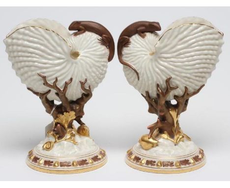 A PAIR OF ROYAL WORCESTER NAUTILUS SHELL VASES, 1884, surmounted by a bronzed lizard and supported on a coral and shell pedes