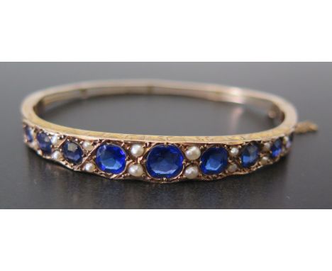 An Edwardian 9ct Gold, Sapphire and Pearl Hinged Bangle, Birmingham 1902, NB, 8.8g, in a contemporary hinged case