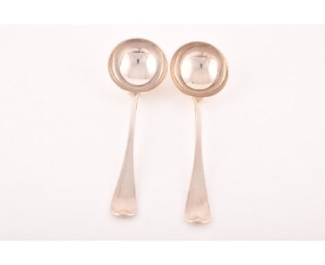 A pair of Victorian silver sauce ladles, hallmarked London 1876, by George Adams, round bowl, rat tail pattern, engraved cres