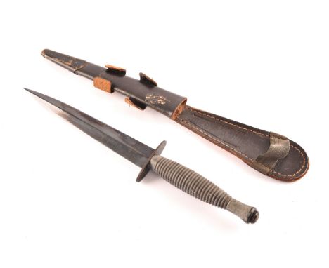 An FS Fairbairn Sykes British Commando dagger, with ribbed metal hilt and crossguard, the double edged stiletto blade stamped