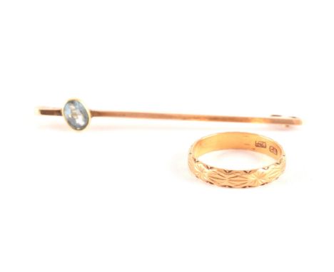 A yellow gold engraved wedding band, size K, along with a yellow metal pin brooch, measuring approximately 5cm. (2)  Conditio