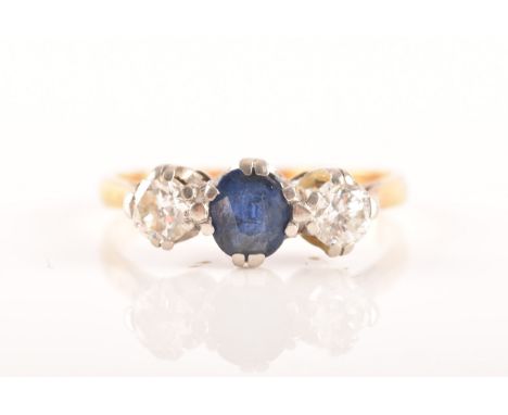 An 18ct yellow gold three stone sapphire and diamond ring, set to centre with an oval sapphire with an approximate weight of 