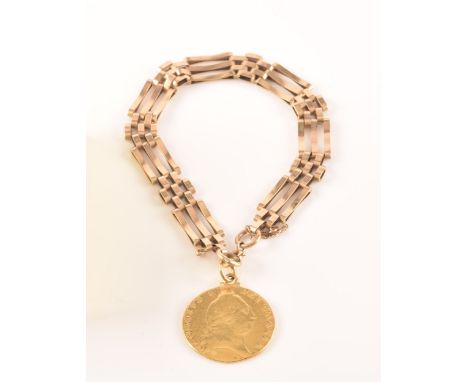 A 9ct yellow gold gate-link bracelet, suspended with a George III spade guinea coin, the bracelet marked 375 (safety chain a/