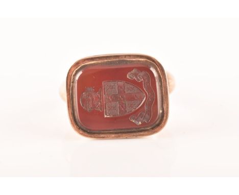 A rose metal compass watch fob, set with a carnelian seal, featuring a compass to reverse, approximately 3.5cm in length, 2.8