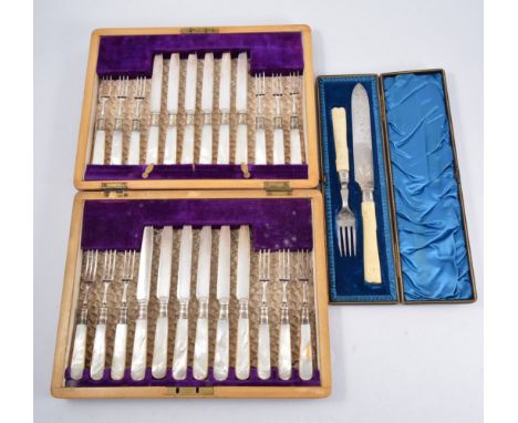 Set of twelve Edwardian dessert knives and forks, plated blades, silver ferrules mother-of-pearl handles, walnut case, and a 