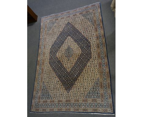 Hamadan carpet, central ivory coloured lozenge medallion on a blue ground, border within guards, 390 x 266cm.