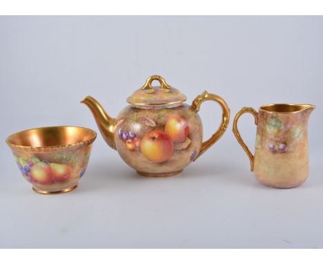 Royal Worcester three-piece teaset, still life painted with fruit, the teapot and cover 14.5cm, signed R English; milk jug 11