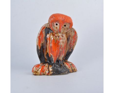 Eric Leaper, a large pottery model of an owl on a branch, running burnished orange glaze over a manganese body, 25.5cm high