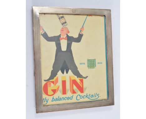 Rectangular silver mounted photograph frame, engine turned, marks worn, probably Edwardian, 29.5cm x 23.5cm, oak easel back; 
