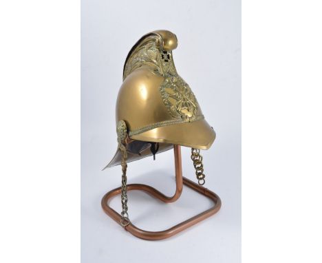 Late Victorian embossed brass fireman's helmet, applied badge with double axe, chain chin strap, 36cm.