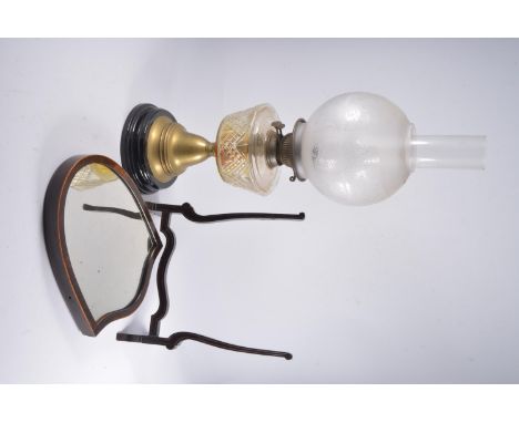 Edwardian oil lamp, moulded glass reservoir, brass column with shade and funnel, height 54cm, and a shield-shape toilet mirro