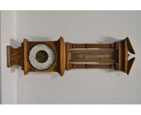 Oak aneroid barometer, with silvered thermometer, height 81cm.