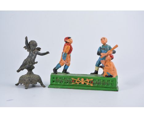 American type painted cast iron mechanical toy, Home Town Battery, 23cm; and a spelter model of a cherub. (2)