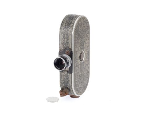 A Bell &amp; Howell Filmo Model 75 Automatic 16mm Cine Camera, silver, body G-VG, some light corrosion throughout, motor appe
