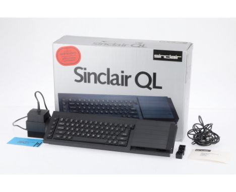A Sinclair QL Computer, black, condition VG, powers on, with console, PSU, video cable, in maker's packaging.