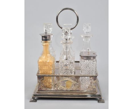 A Late Victorian/Edwardian Six Bottle Cruet having Silver plated Rectangular Stand and Ring Handle, 26cms High 