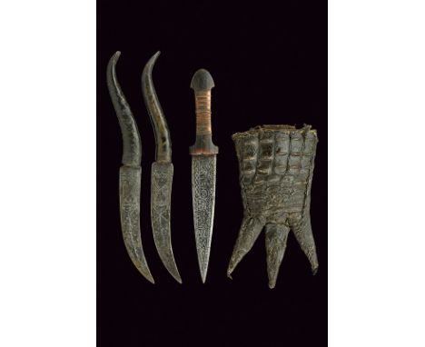 A trousse with three daggers dating: circa 1900 provenance: Sudan The central one with blade featuring inscriptions in Thulut