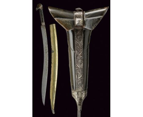 A yatagan with scabbard dating: 19th Century provenance: Turkey Curved, single -and false-edged blade with rear groove, featu