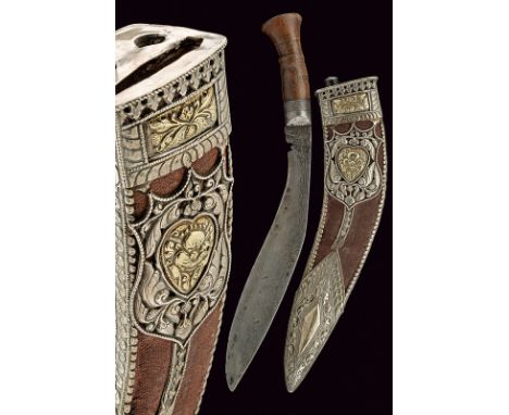 A fine kukri dating: circa 1900 provenance: India Typical, curved, single-edged blade engraved near the back; wooden grip wit