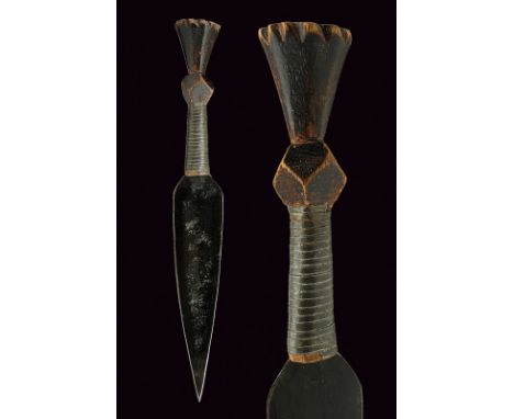 A small dagger dating: circa 1900 provenance: Africa Flat, double-edged blade; sculpted, wooden grip. The base bound by iron 