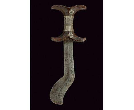 A Beja dagger dating: circa 1900 provenance: Egitto Straight, double-edged blade with curved tip and central raiser; specular