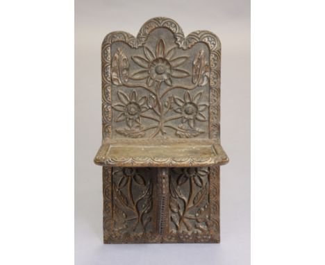 A 17th century and later carved oak wall bracket with shaped pediment &amp; all-over carved floral decoration, 32cm wide x 61