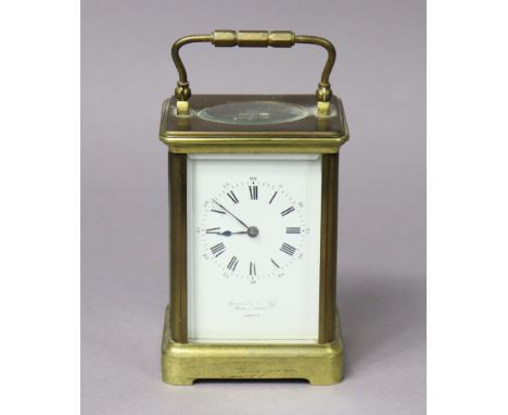 A late 19th century brass-cased carriage clock retailed by Howell James &amp; Co., London, 9cm wide x 14cm high.