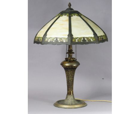 A 20th century bronzed metal table lamp inset opaque glass panels to the foliate shade, on spiral-fluted column &amp; flared 