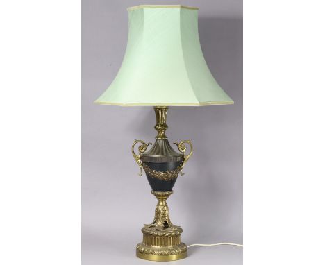 A 20th century gilt metal &amp; ebonised table lamp of vase form on large cicular plinth base, with shade, 95cm high.