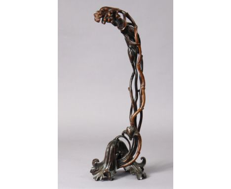 A 19th century Chinese lacquered or stained boxwood carving in the form of entwined branches &amp; blossoms on splayed leaf-s
