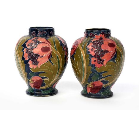 A pair of Bursley Ware Seed Poppy vases designed by Charlotte Rhead, shouldered form, tubeline decorated with flowers and fol