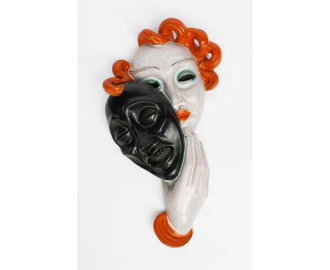 A Goldscheider Pottery Comedy wall mask, model no.6288, modelled as a woman with stylised features and orange hair, holding a