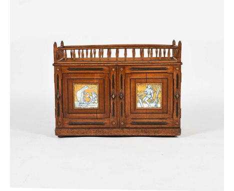 A Gothic Revival oak cabinet set with Mintons Art Pottery Cricket and Boating tiles, from the Old English Sports and Games Se