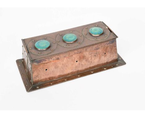 A patinated copper box in the manner Jesson Birkett and Co, tapering, rectangular form, the hinged cover with three 'Ruskin' 