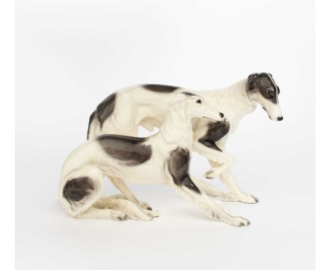 A large Goldscheider Pottery model of two Borzoi dogs, no.6011, one standing the other lying down, glazed in colours, another