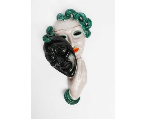 A Goldscheider Pottery Comedy wall mask, model no.6288, modelled as a woman with stylised features and blue hair, holding a m