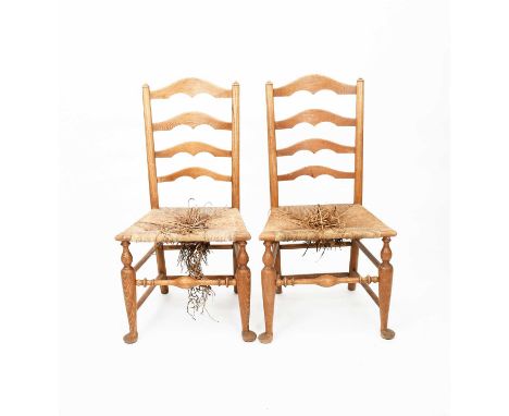 A pair of ash ladderback chairs designed by Sir Edwin Lutyens, for Deanery Garden, with rush seatunsigned100cm. high (2) Prov